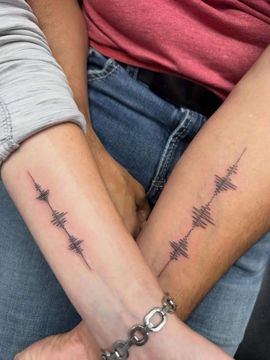 Couple's soundwave tattoos symbolizing connection