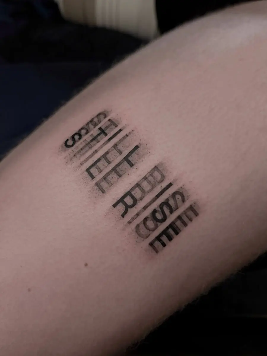Bold text tattoo conveying resilience and strength