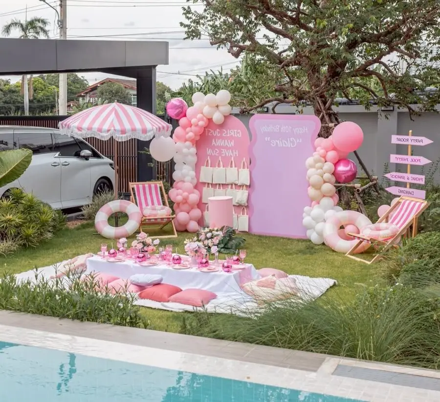 Charming pink-themed poolside decor setup