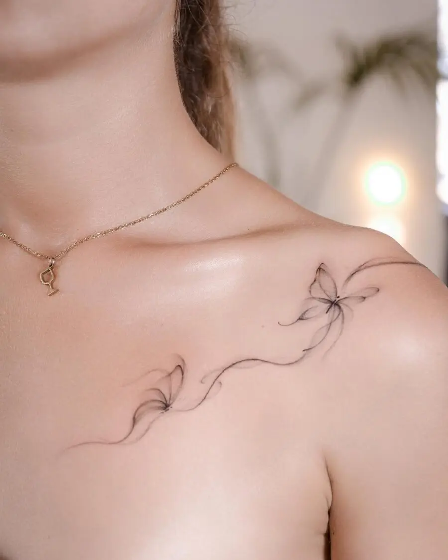 Delicate floral aesthetic tattoo on shoulder