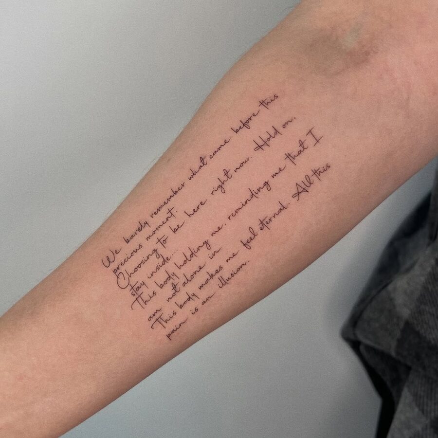 Elegant handwritten quote tattoo on forearm