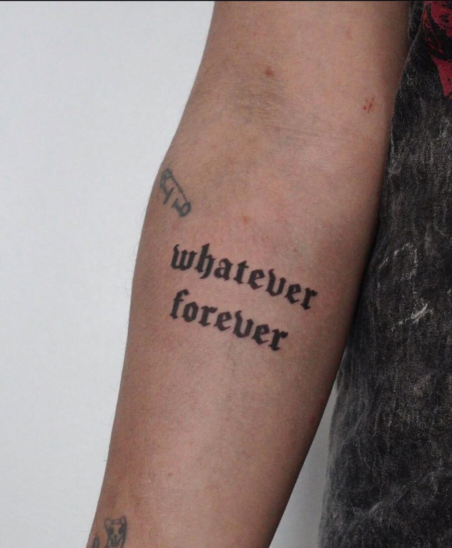 Bold lettering tattoo expressing timeless sentiments