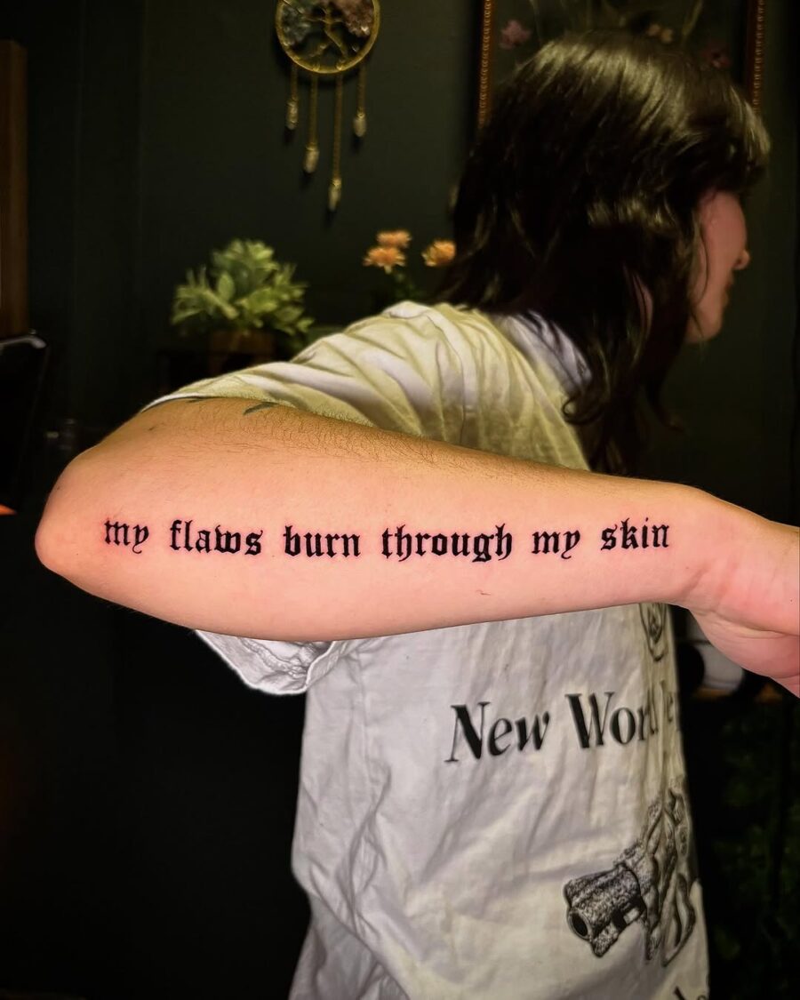 Expressive script tattoo on inner forearm