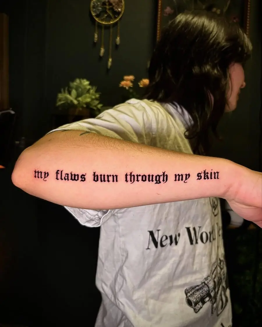 Expressive script tattoo on inner forearm