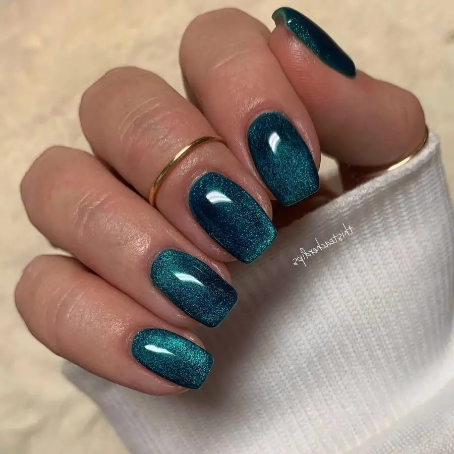 Stylish teal velvet nails with glitter accents