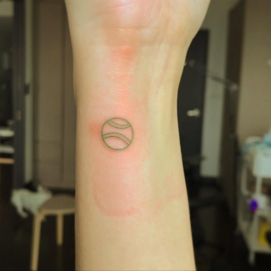 Minimalist Tennis Ball Tattoo on Wrist