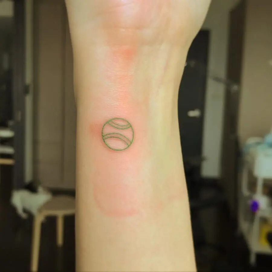 Minimalist Tennis Ball Tattoo on Wrist