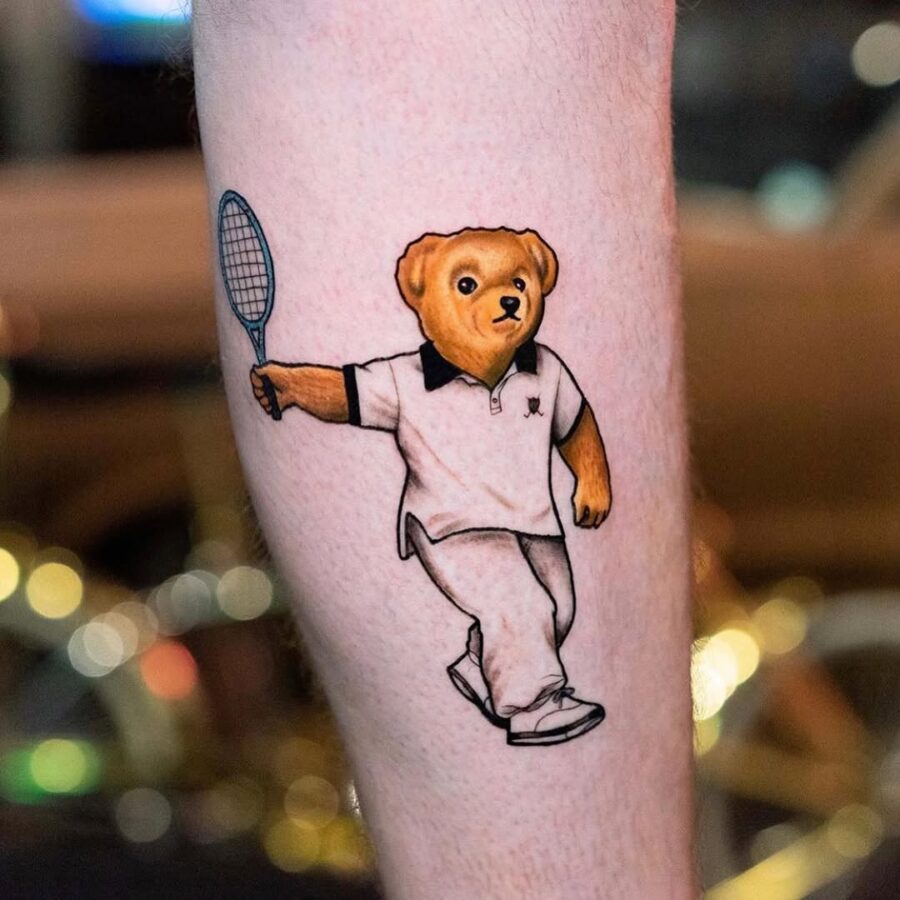Adorable bear playing tennis tattoo design