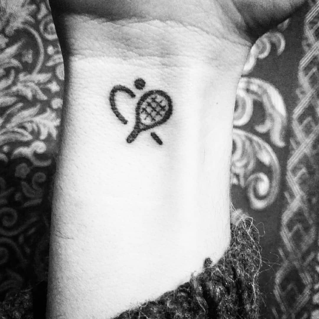 Unique tennis love tattoo on wrist