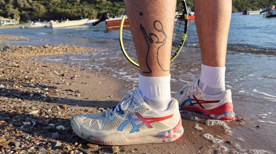 Playful tattoo celebrating tennis on the beach.
