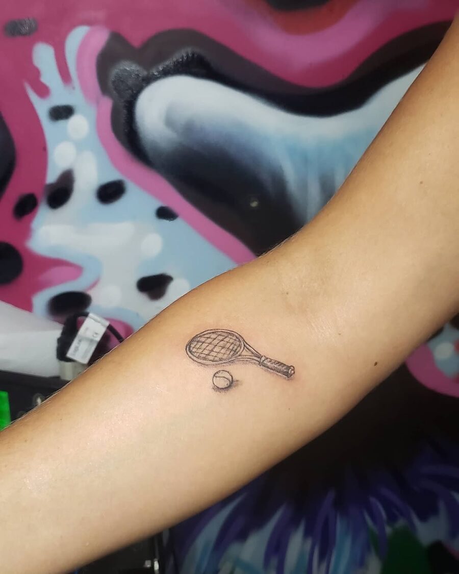 Stylish tennis racket and ball tattoo design