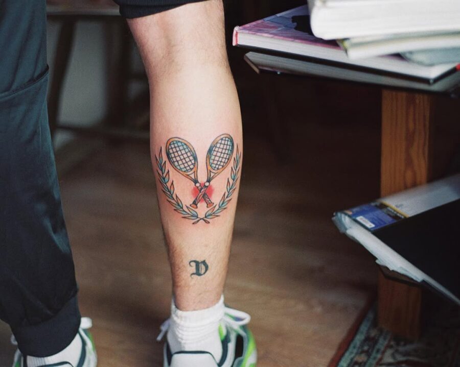 Heartfelt tennis tattoo with rackets and laurels