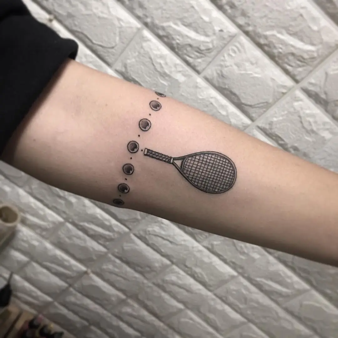 Stylish tennis racket tattoo on forearm