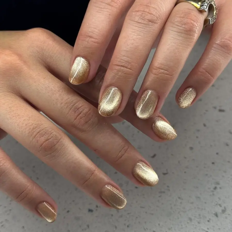 Elegant golden velvet nails with a shimmering finish