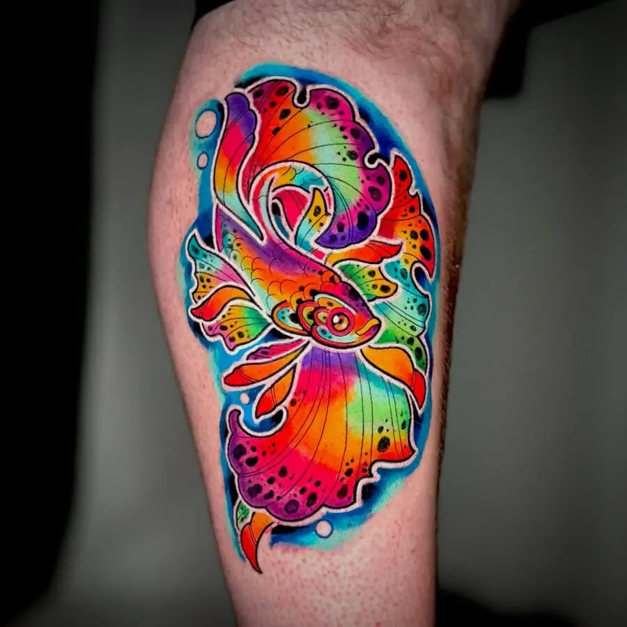 Radiant goldfish tattoo bursting with colors