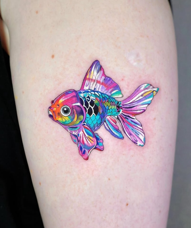 A mesmerizing goldfish tattoo bursting with color
