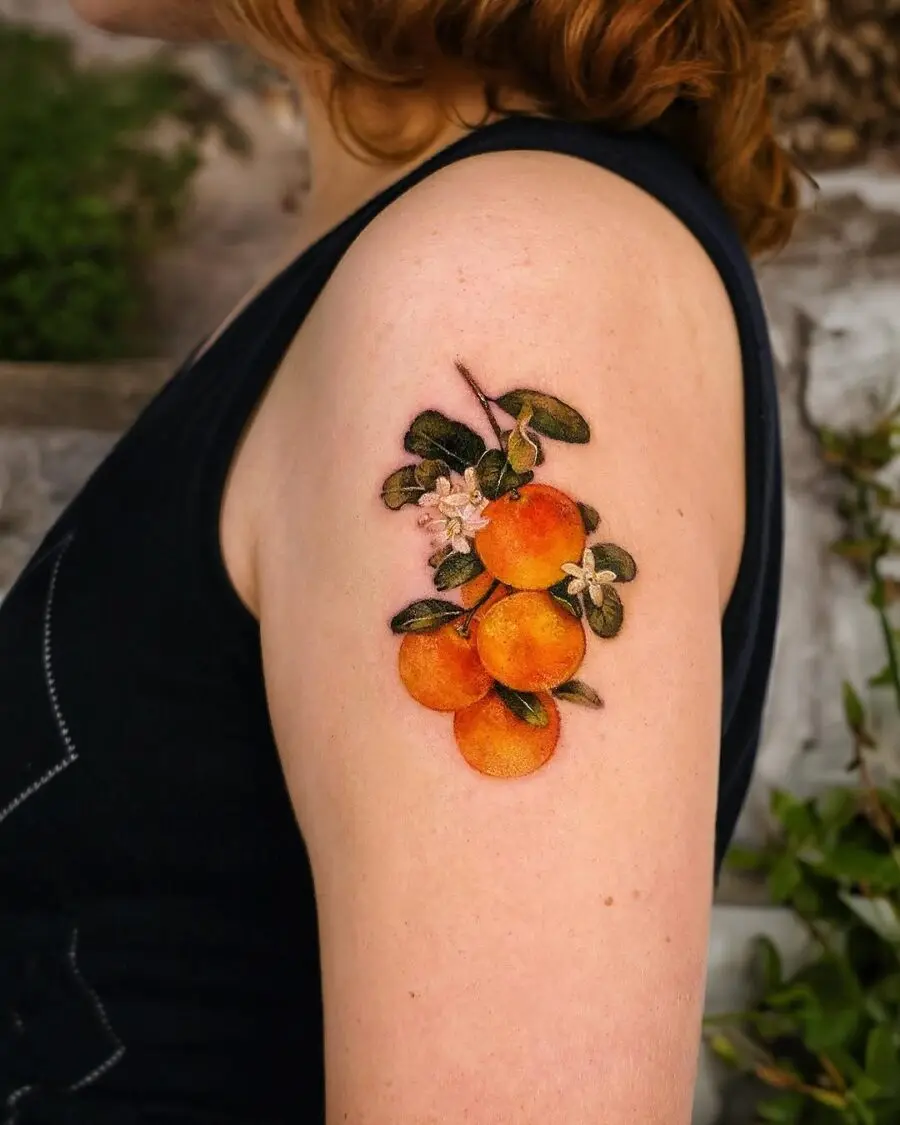 Stunning orange fruit tattoo on arm