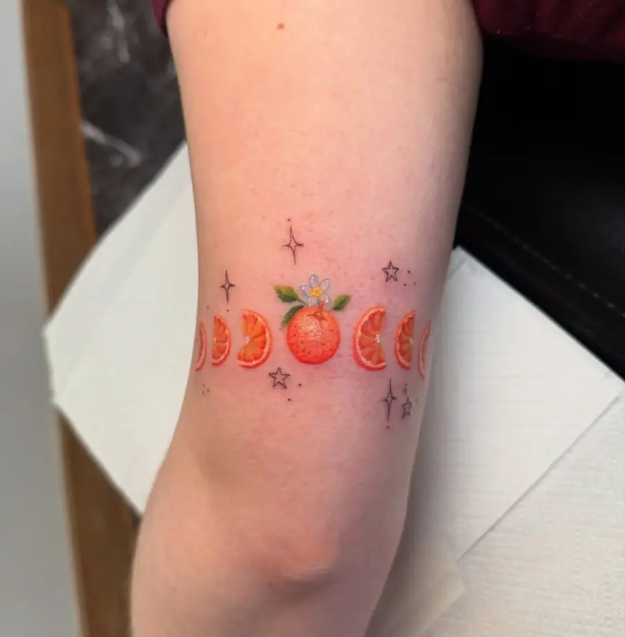 Vibrant Orange Tattoo with Celestial Accents