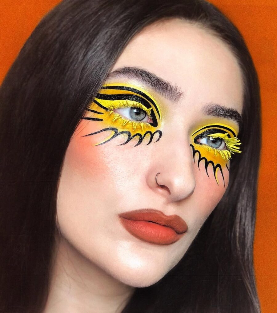 Bold yellow eye makeup with artistic flair