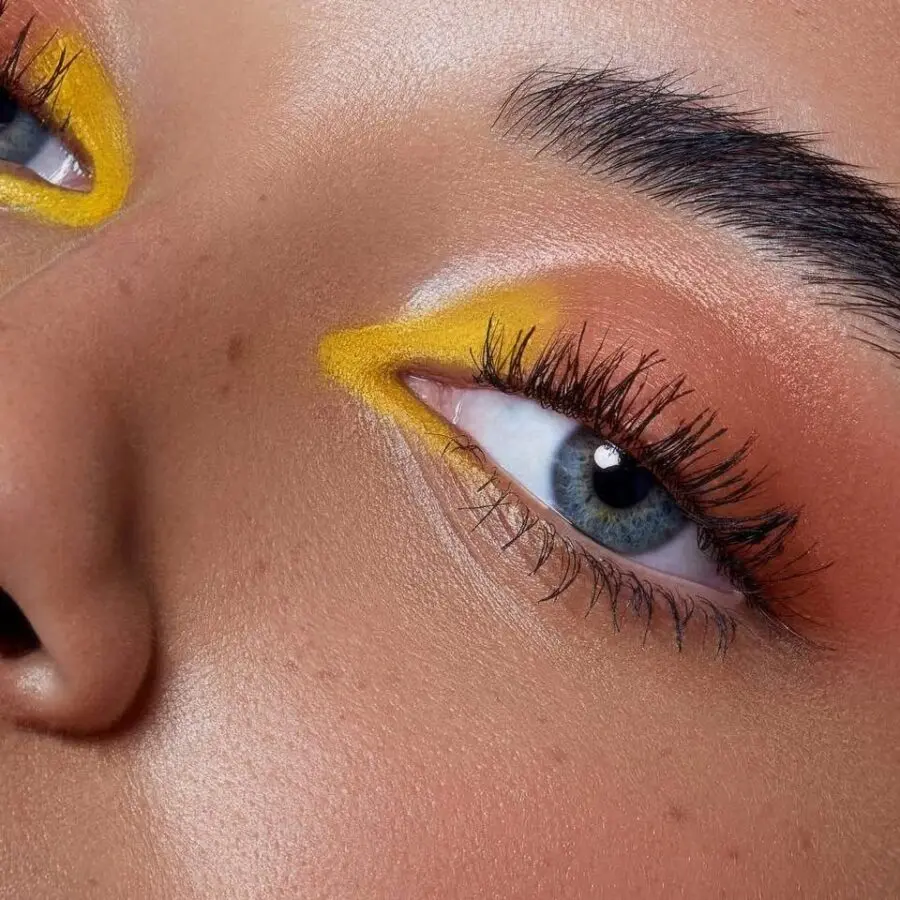 Bold yellow eyeshadow with radiant skin