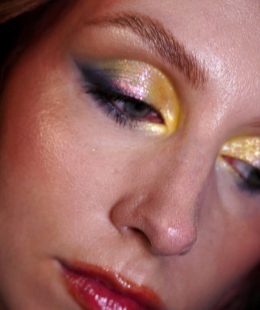 Vibrant yellow eyeshadow with sparkling glitter accents