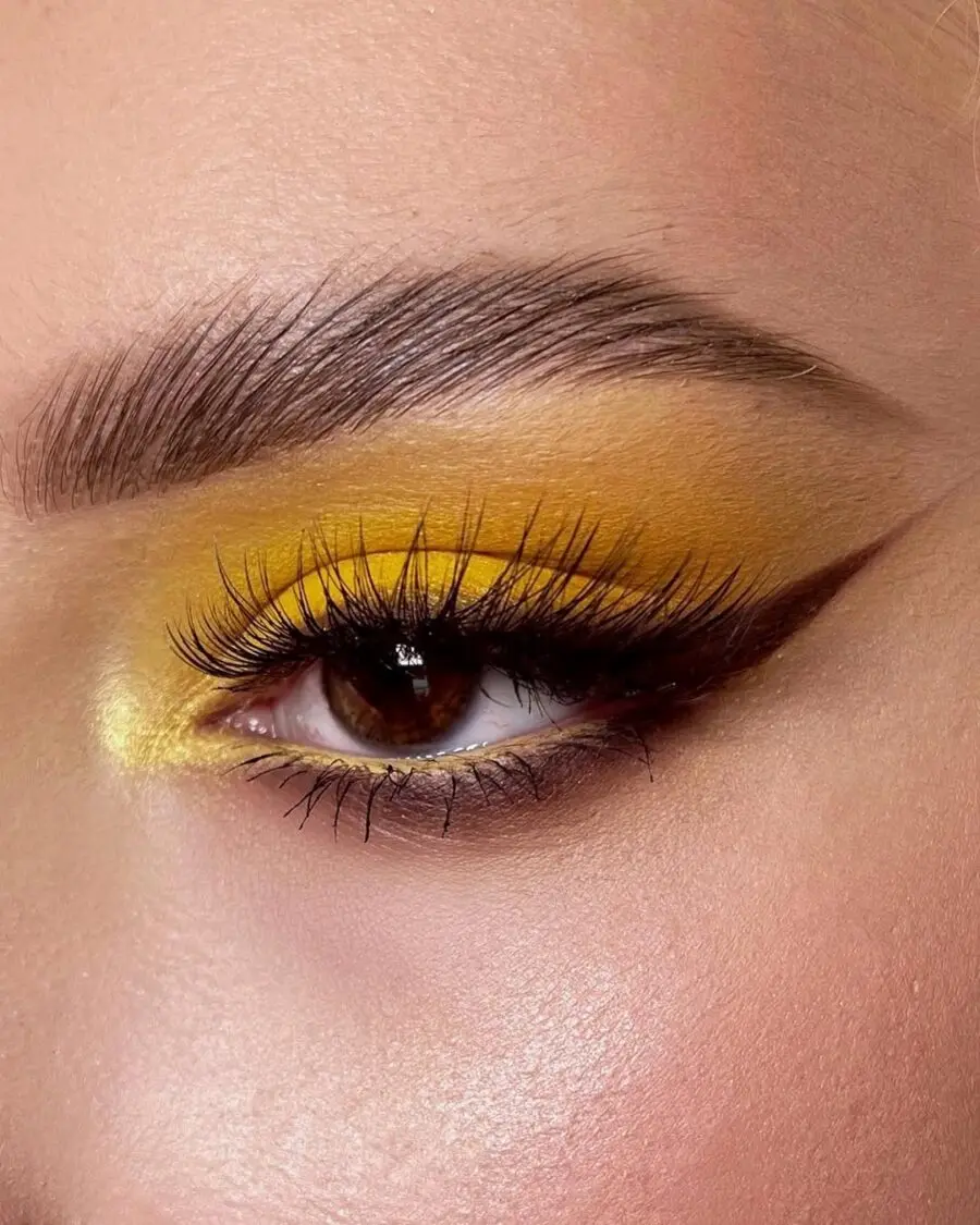Bold yellow eye makeup look with winged liner
