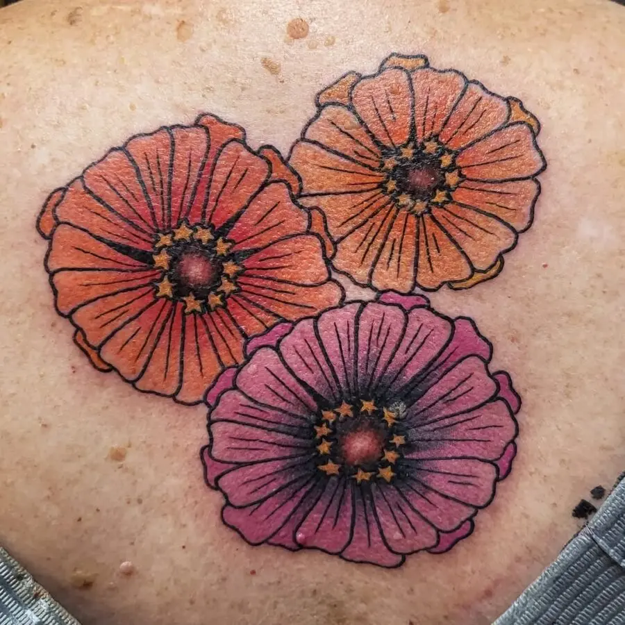 Colorful zinnia tattoos blooming on skin