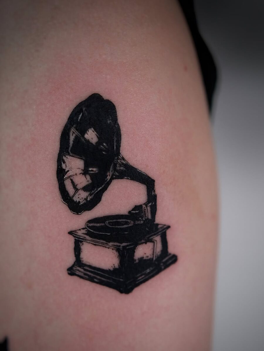 Classic record player tattoo in bold black ink