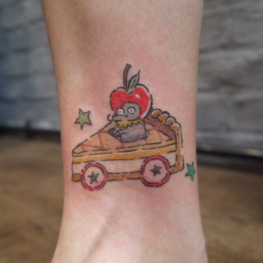 Playful pie tattoo with a cheeky character