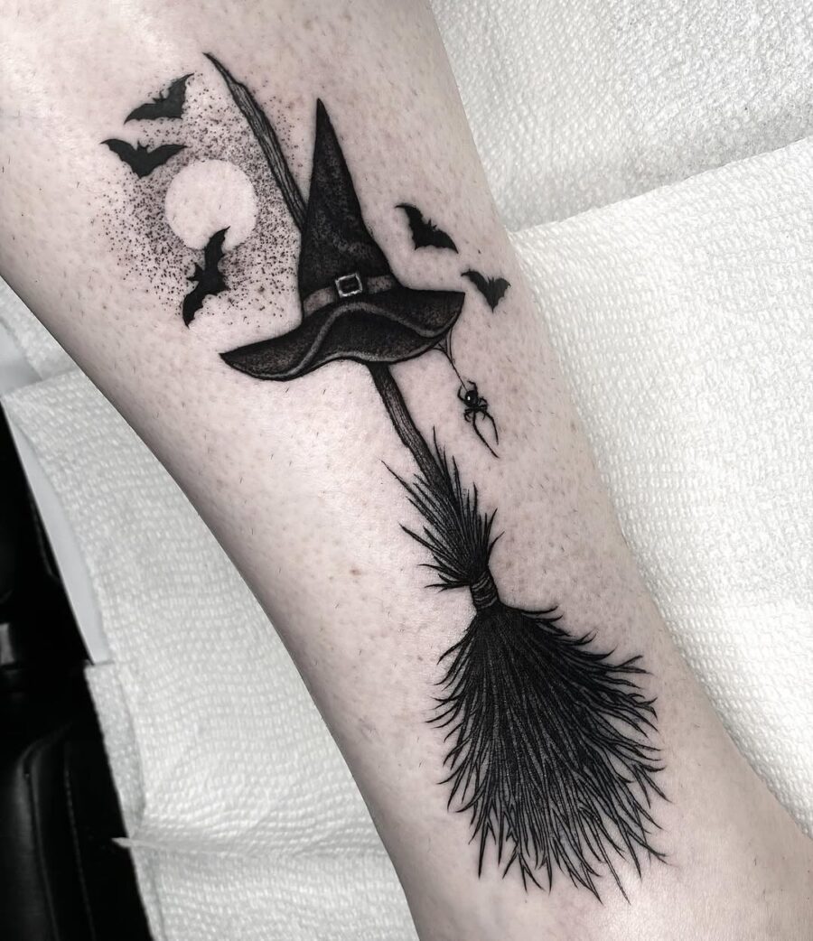 Charming witch hat tattoo with spooky elements