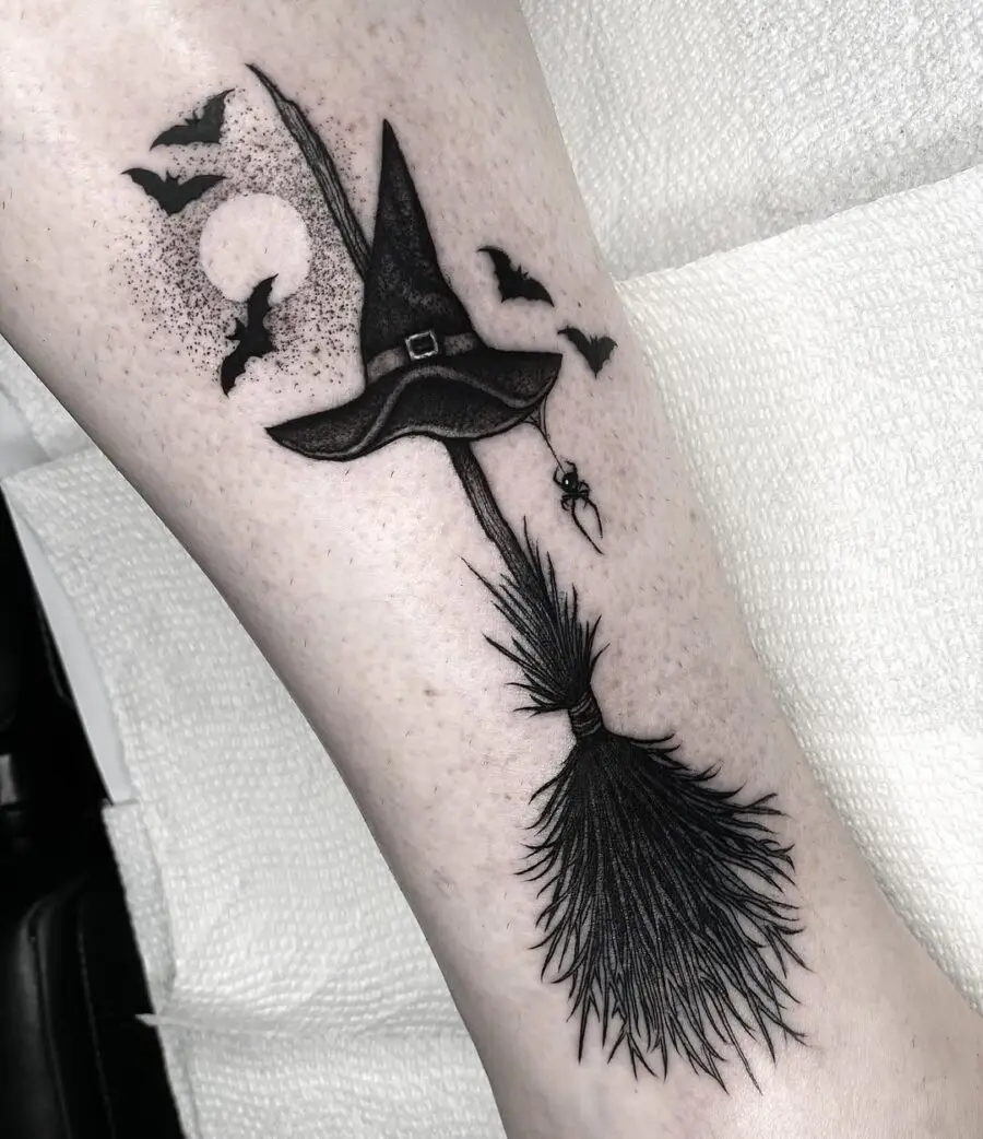 Charming witch hat tattoo with spooky elements