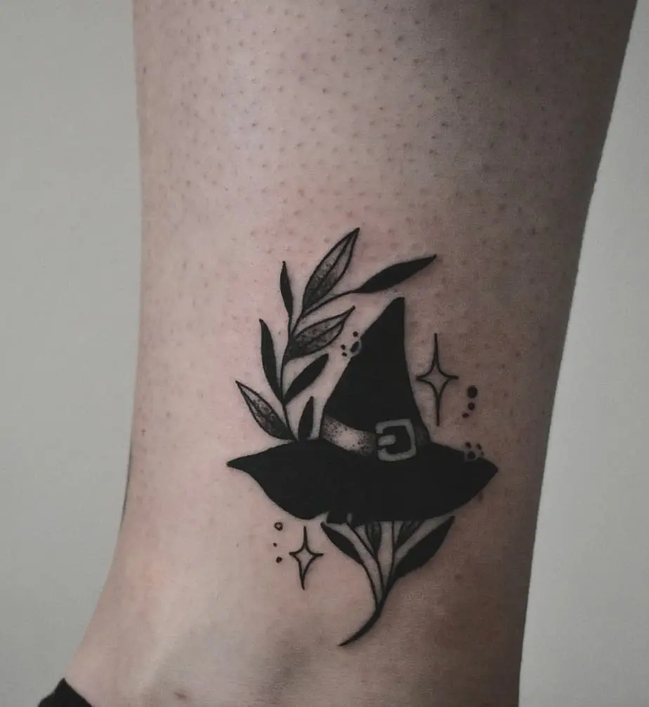 Stylish witch hat tattoo with floral elements