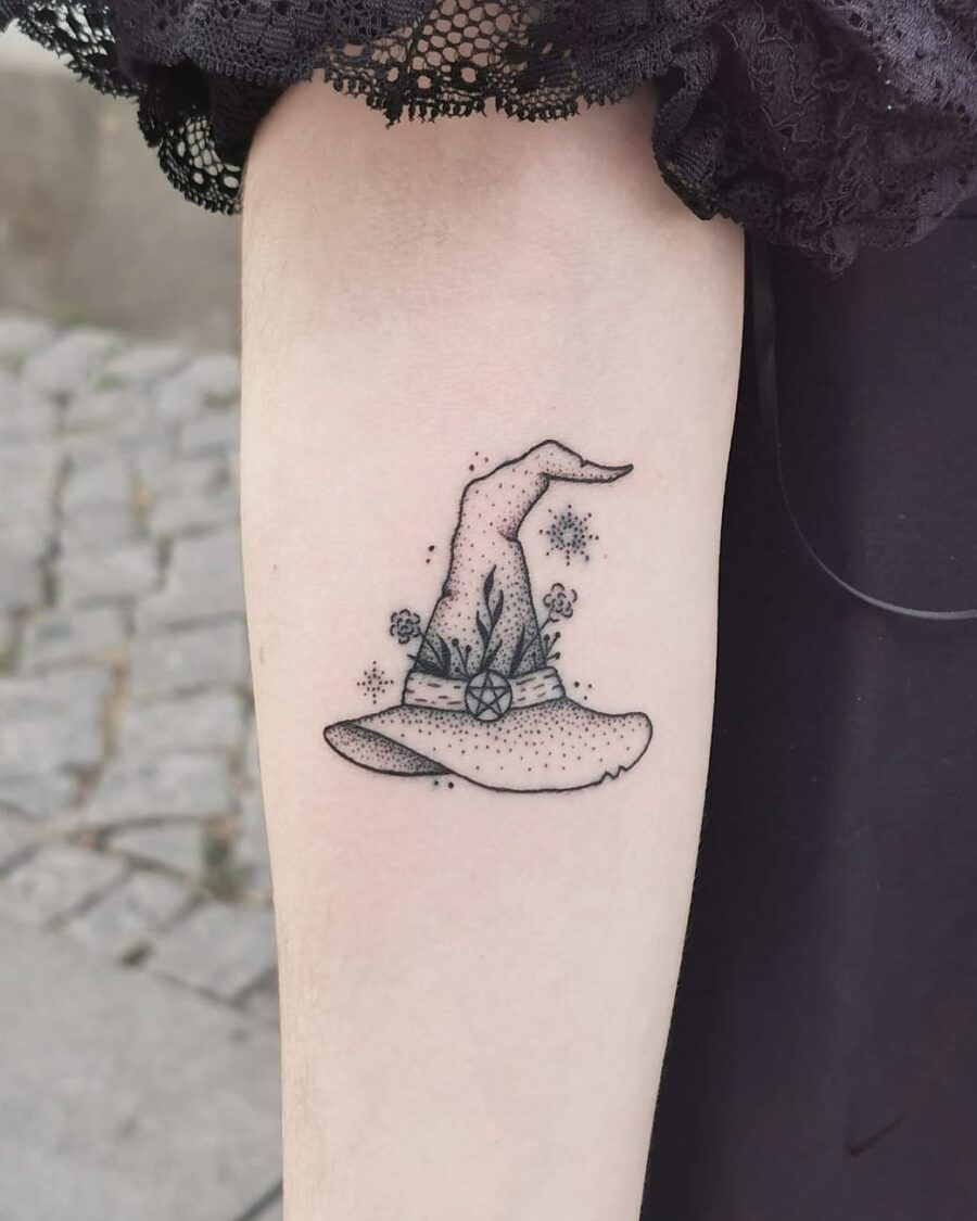 Charming floral witch hat tattoo with a whimsical touch