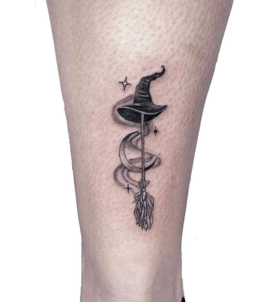 Elegant witch hat tattoo featuring celestial elements