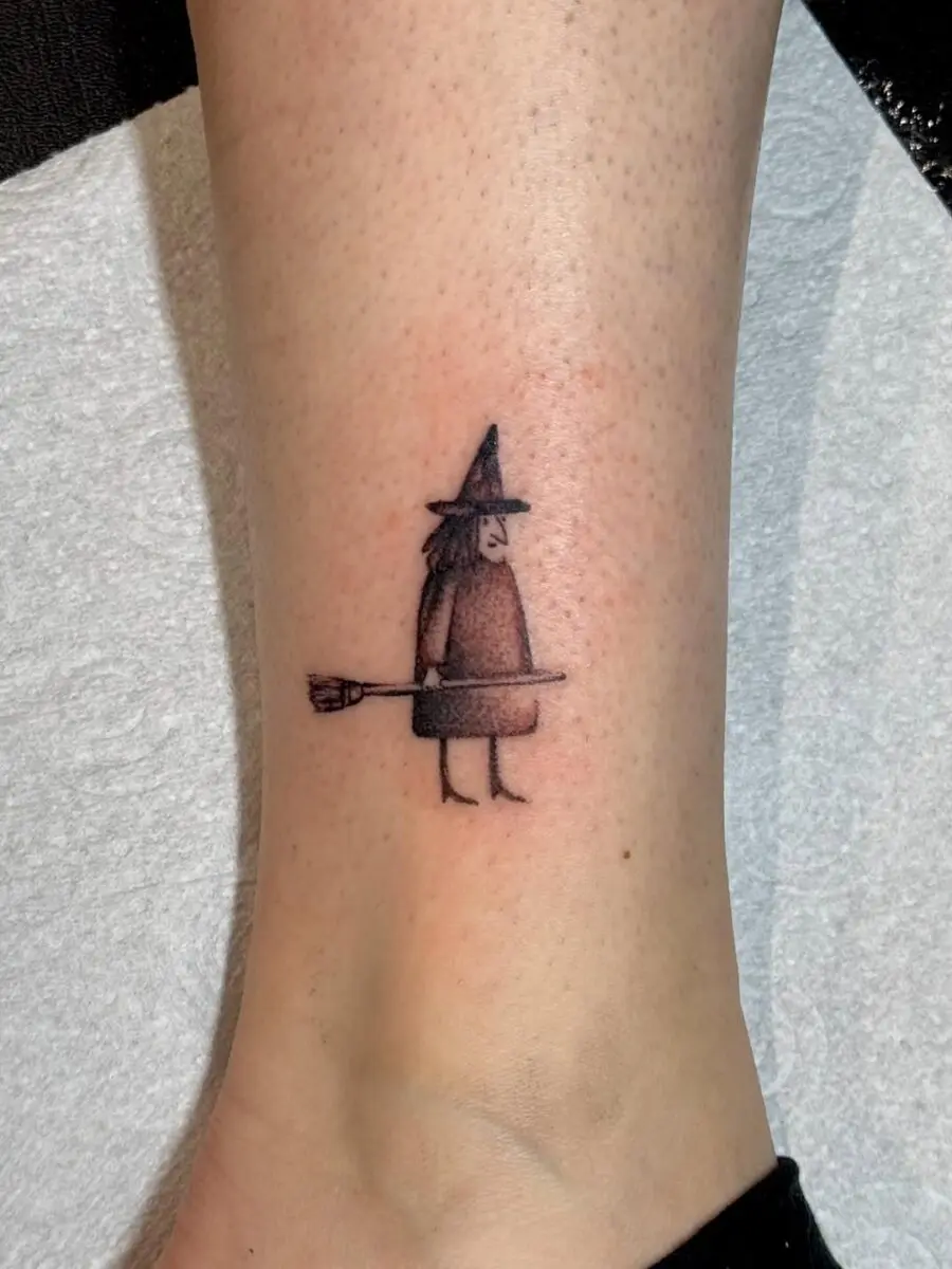 Charming witch hat tattoo with a whimsical vibe