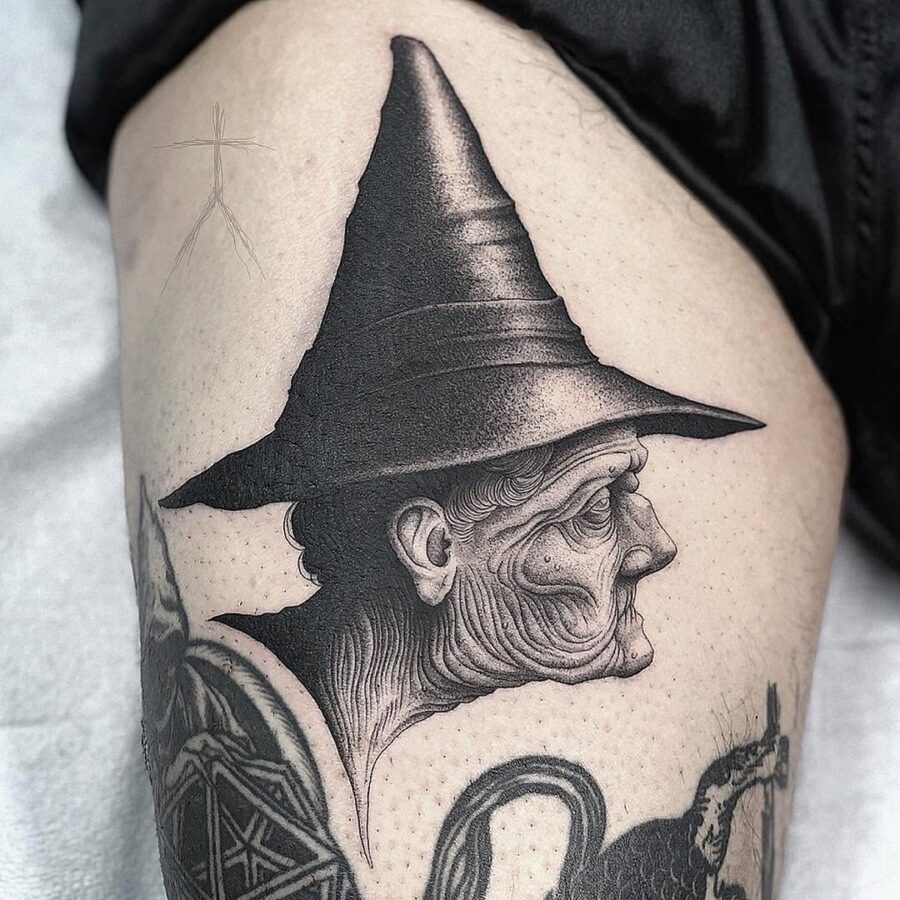 Intricate witch hat tattoo with elderly figure