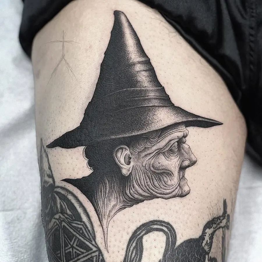 Intricate witch hat tattoo with elderly figure