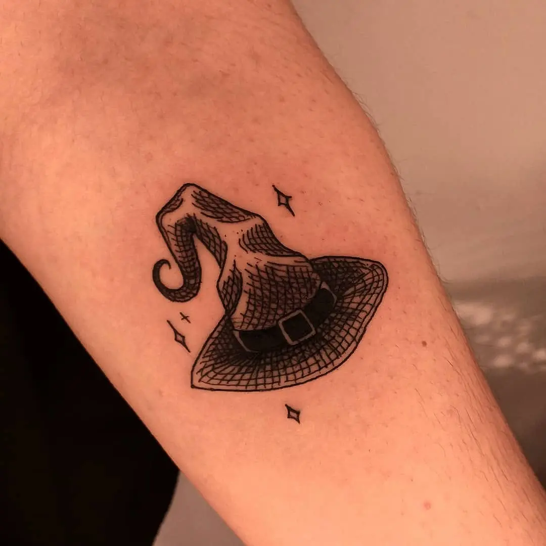 Charming witch hat tattoo with intricate details