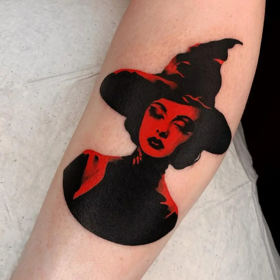 Bold witch hat tattoo with striking contrasts