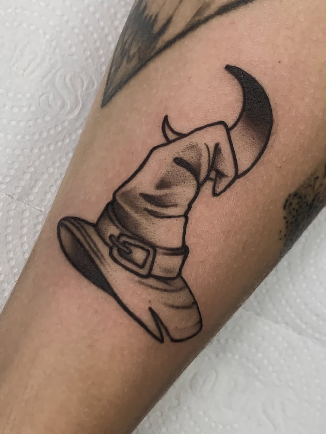 Chic black witch hat tattoo with subtle shading