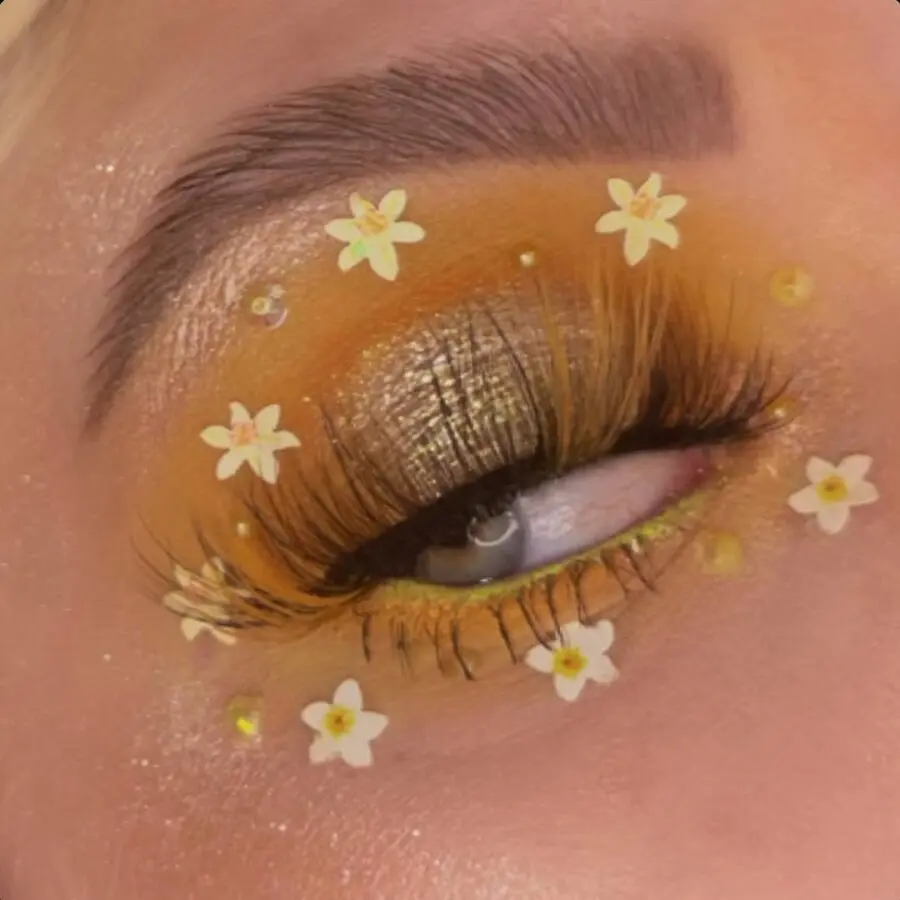 Vibrant yellow makeup with floral accents