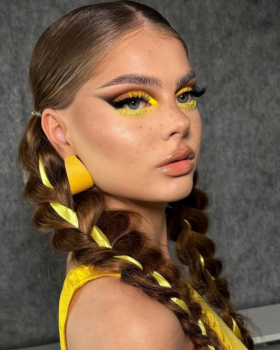 Vibrant yellow makeup with bold braids