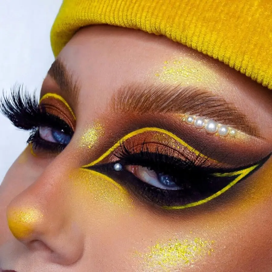 Bold yellow and black makeup look with flair