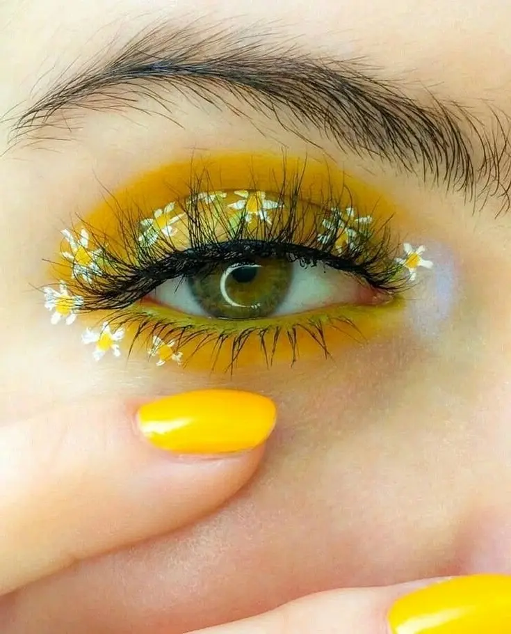 Vibrant yellow eye makeup with floral accents