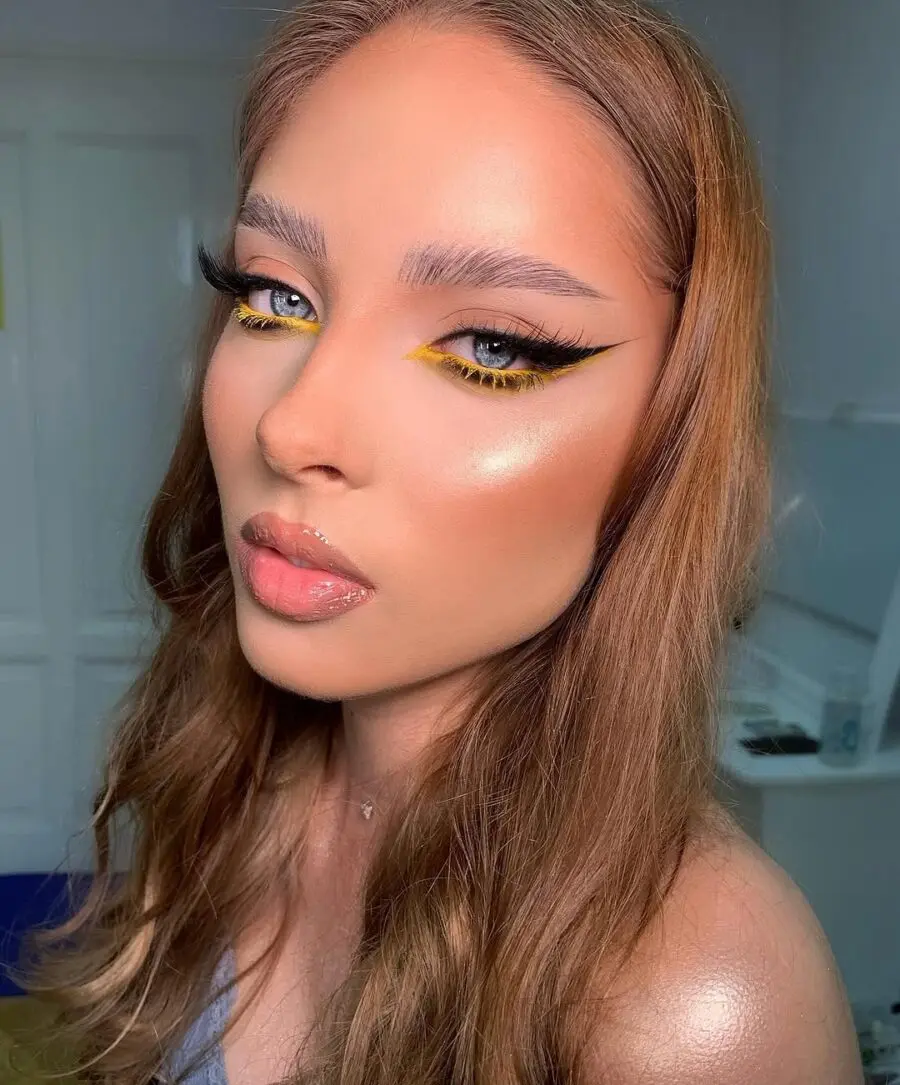Vibrant yellow eyeliner meets glowing skin