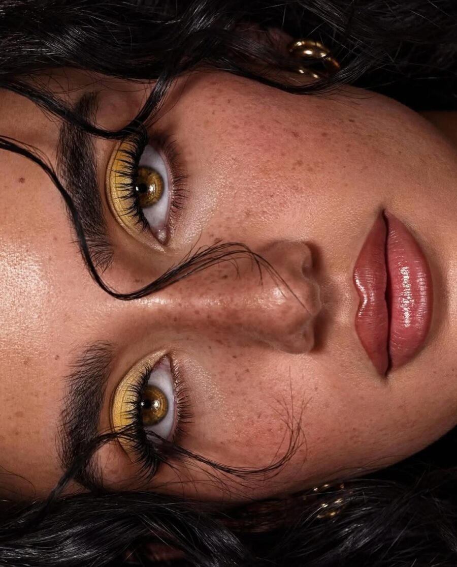 Bold yellow eyeshadow enhances natural beauty