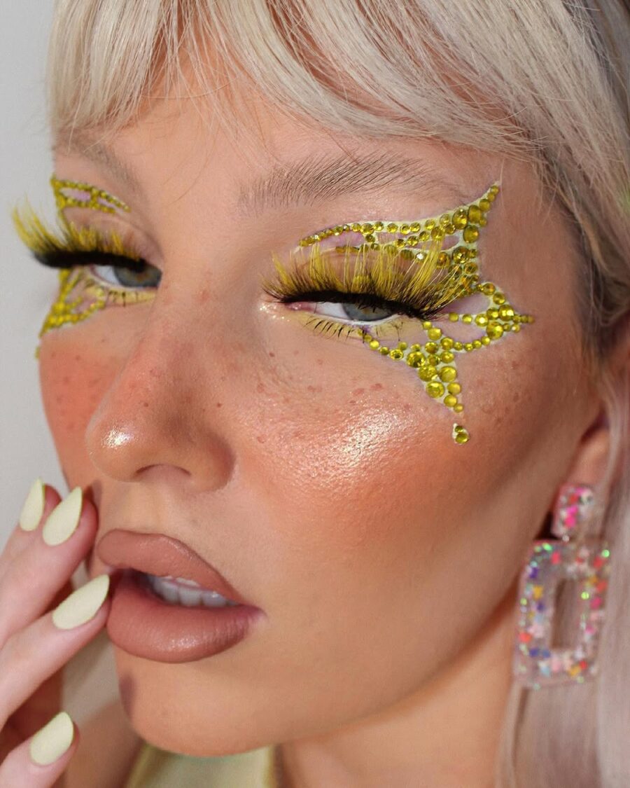 Vibrant yellow eye makeup with gemstone accents