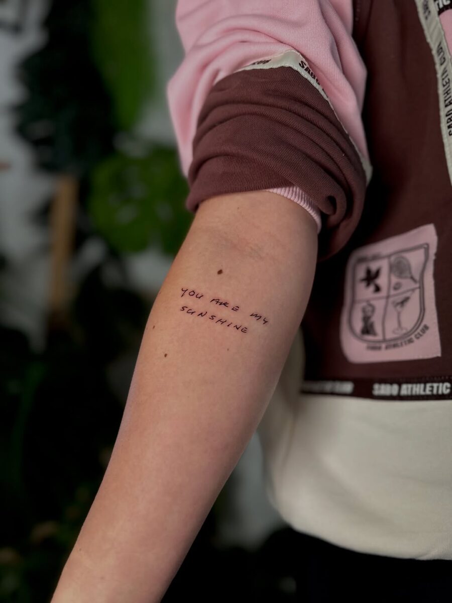 Delicate handwriting tattoo with warm message