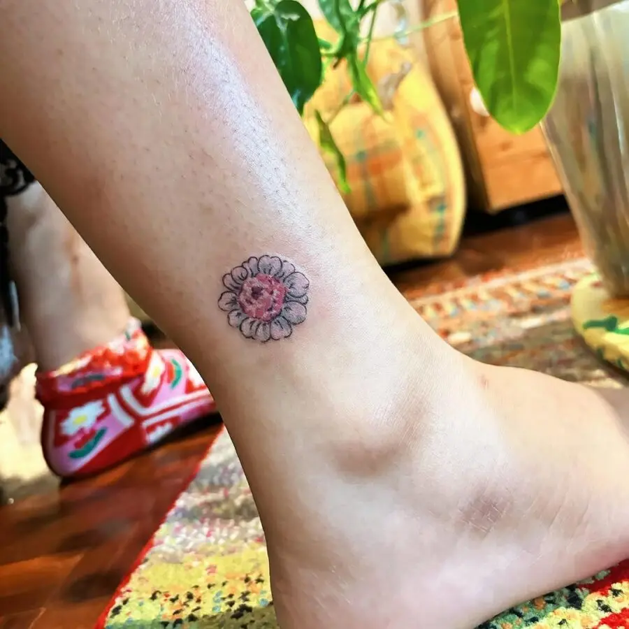 Charming zinnia tattoo on the ankle