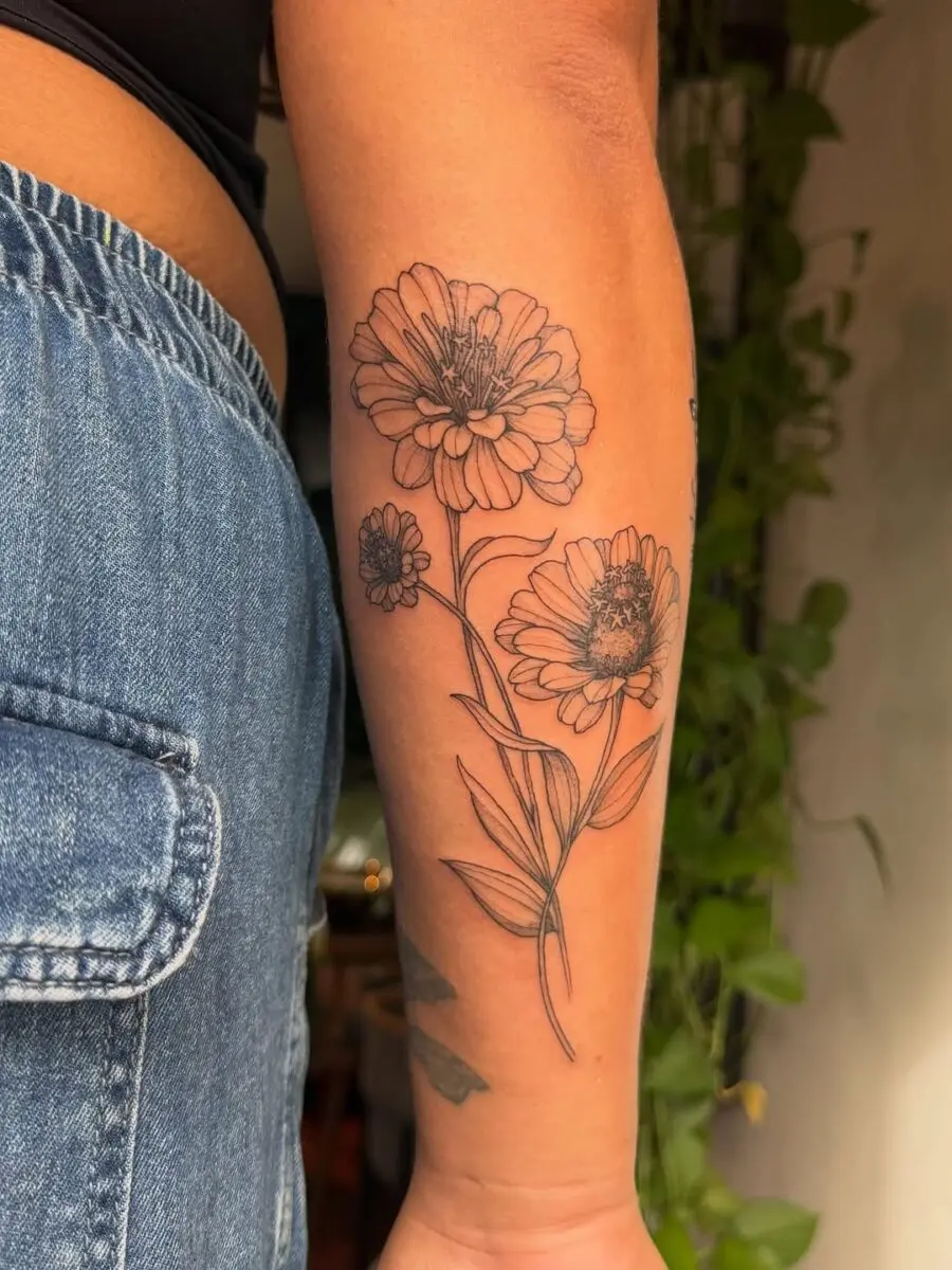 Elegant black ink zinnia flower tattoos